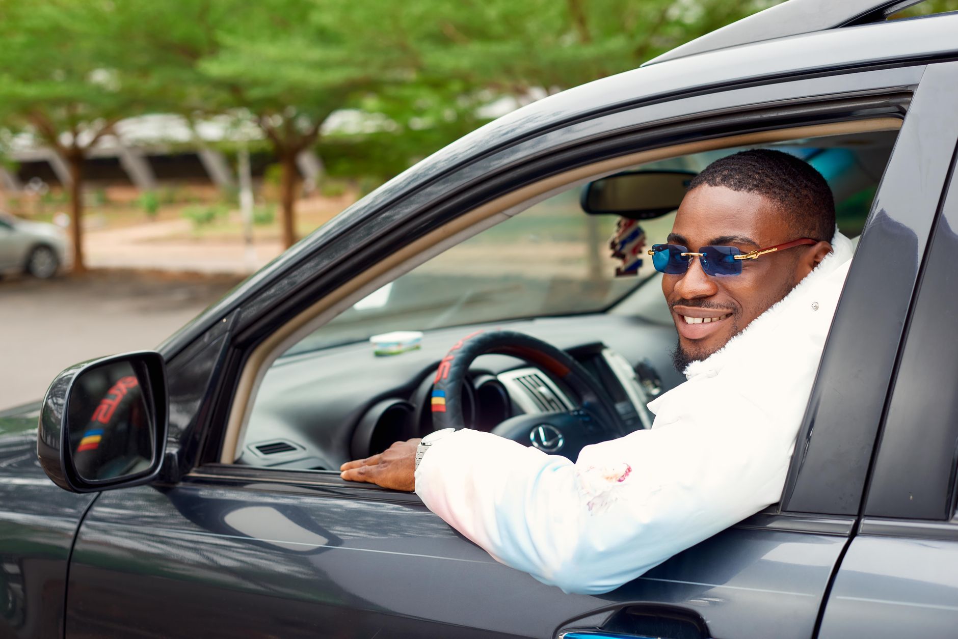 A satisfied customer in the driver's seat of their car